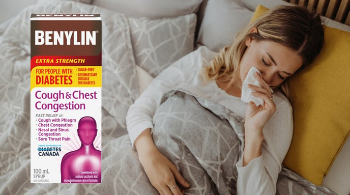 BENYLIN® Extra Strength Cough & Chest Congestion Syrup for People with Diabetes and a woman lying in bed and coughing.